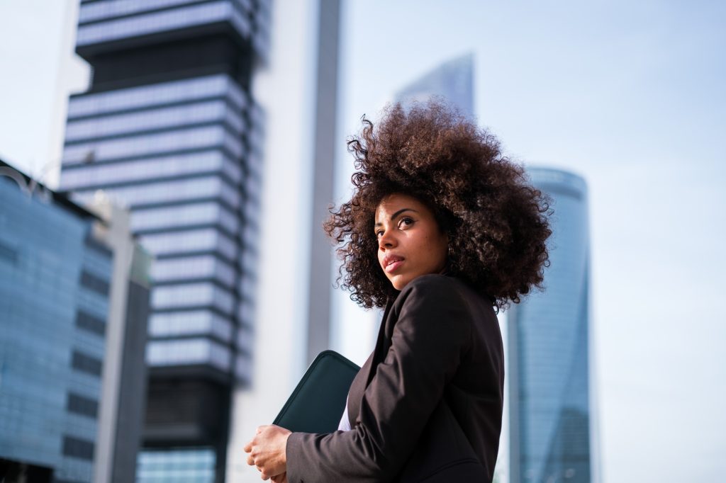 Half-length shot of empowered woman in financial district