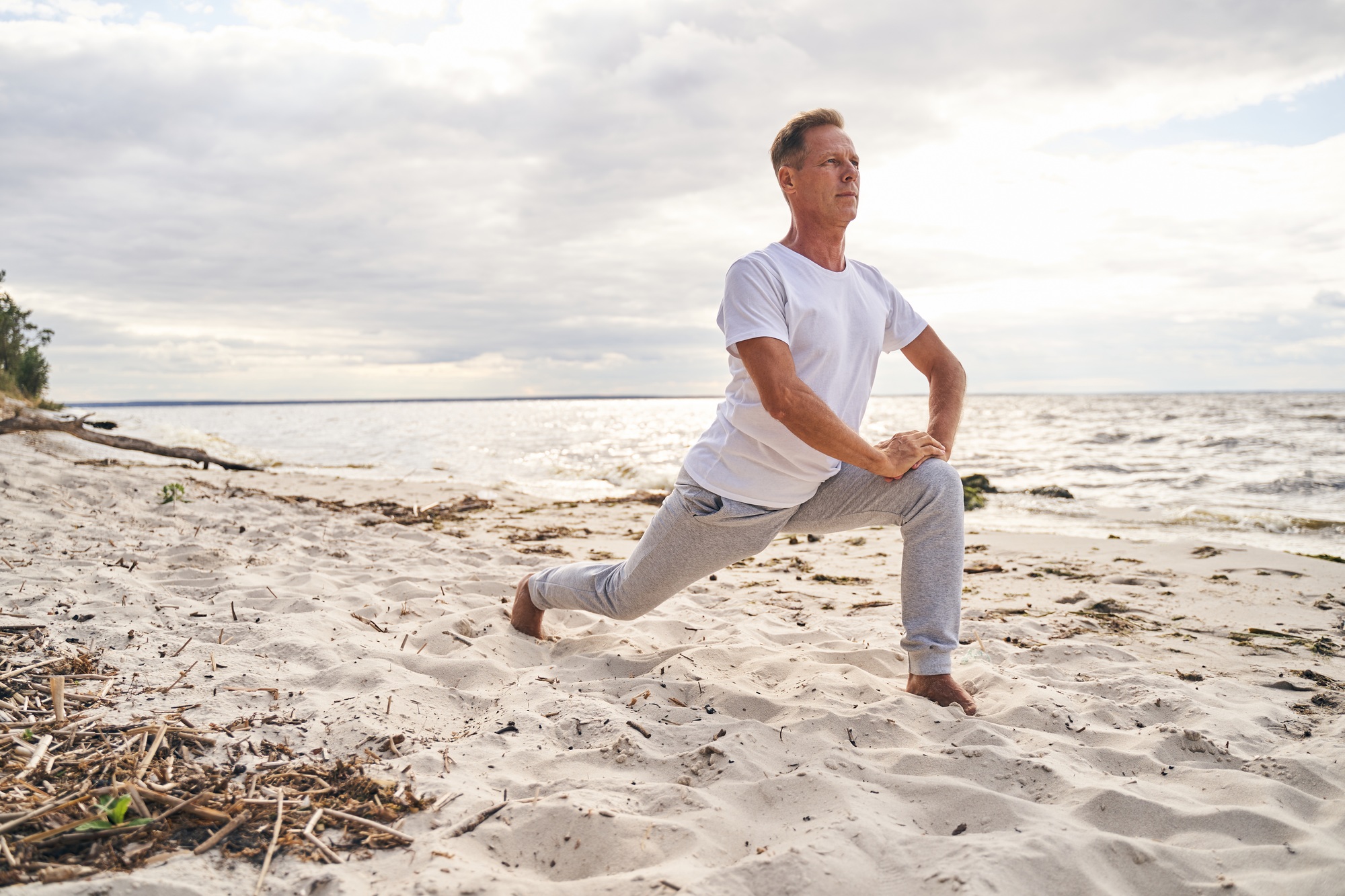 Lean man starting morning with training outdoors