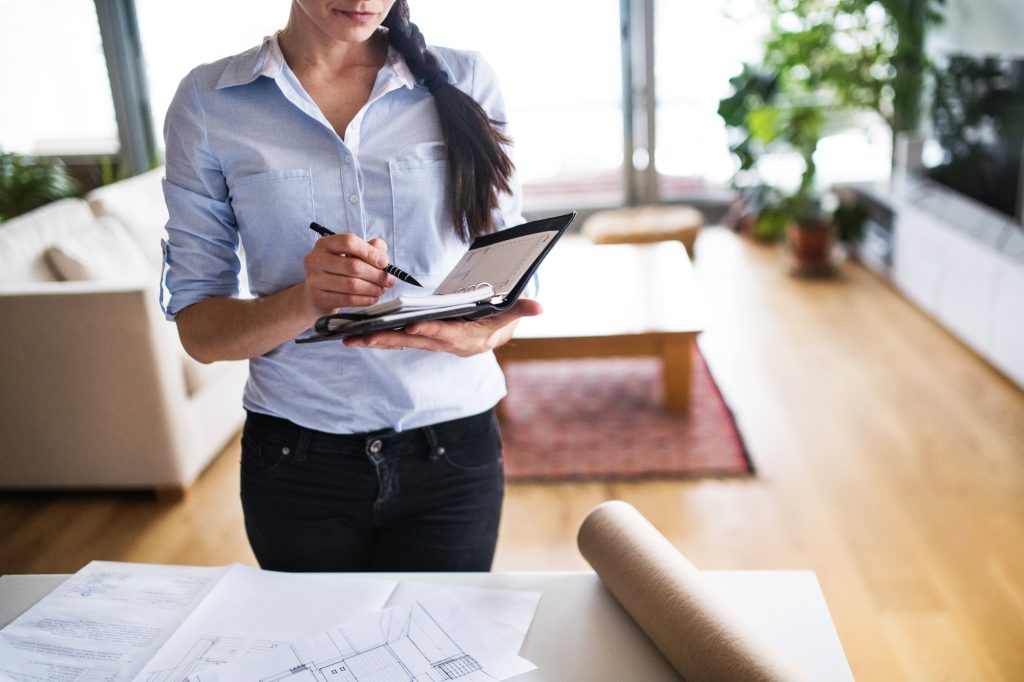 Young woman using a personal diary at home.